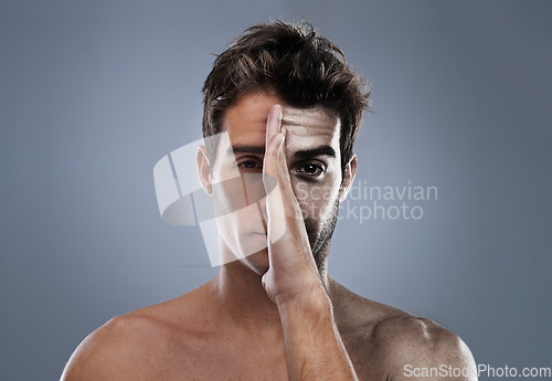 Image of Man, hand and half face or shave for hair removal on grey background for transformation, comparison or before and after. Male person, portrait and cleaning beard care for health and mockup space