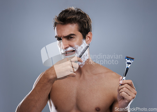 Image of Man, choice and razor in studio, shaving cream or portrait for grooming by grey background. Person, model and decision for blade with beard, facial hair removal and doubt product for cosmetic change