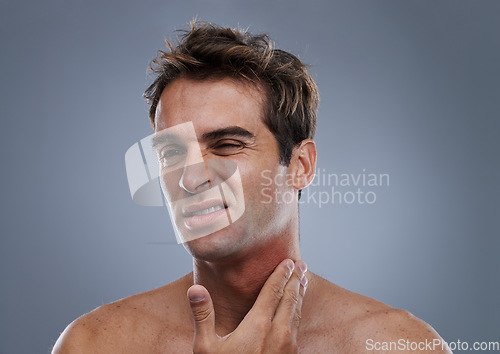 Image of Man, shave and rash pain from razor burn for hair removal for hygiene maintenance, mistake or grey background. Male person, hand and unhappy in studio or care fail in inflammation, itchy or mockup