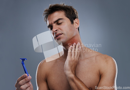 Image of Man, shaving and beard or razor pain for hair removal or red rash, inflammation or grey background. Male person, tool and cleaning in studio or accident for wellness maintenance, burn or mockup space