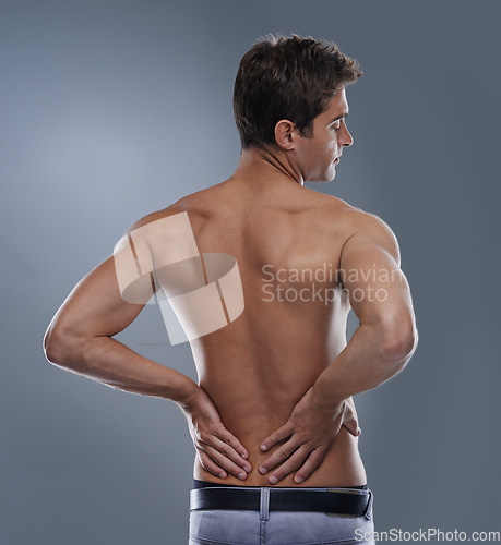 Image of Back pain, injury crisis and studio man with medical emergency, sore spine or osteoporosis. Backache, anatomy and person massage joint ache, accident or hurt muscle strain on grey background