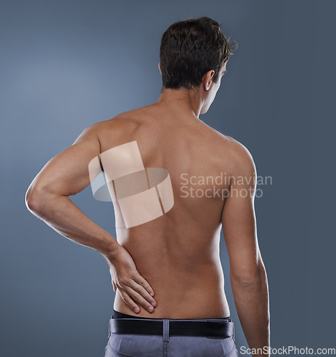 Image of Back pain, injury crisis and studio person with medical emergency, sore spine or osteoporosis. Backache, arthritis and model massage joint ache, accident or hurt muscle strain on grey background