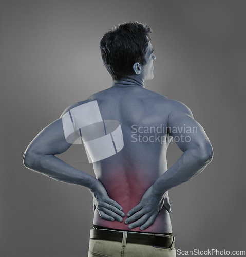 Image of Back pain, injury crisis and studio man with medical emergency, sore spine or fibromyalgia. Backache, red glow and person massage joint ache, inflammation or bad muscle strain on grey background