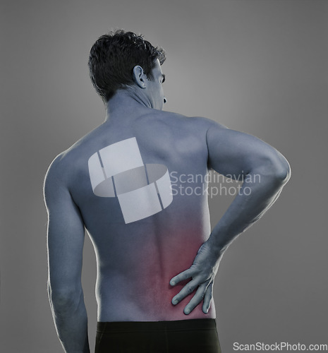 Image of Man, back pain and spine problem in studio, medical crisis and muscle tension or injury of training. Model, joint ache and sore with inflammation of sport accident and red glow by grey background