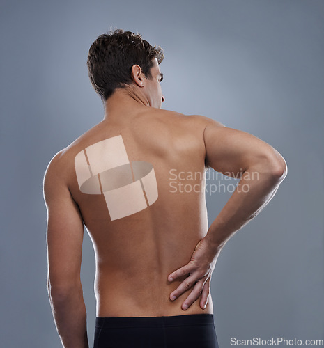 Image of Injury, crisis and studio man with back pain emergency, sore spine or chiropractic backache. Osteoporosis, orthopedic problem and person with body ache, accident or muscle risk on grey background