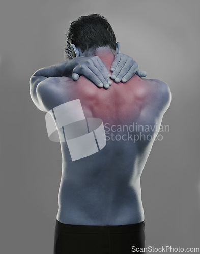 Image of Back, man and red highlight for neck pain, burnout and muscle tension on a grey studio background. Person, sore and model with inflammation and body ache with bruise and broken with strain and injury