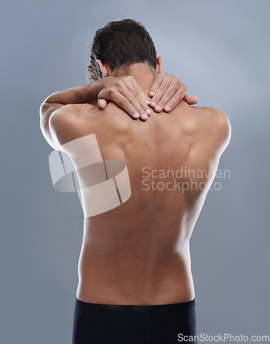 Image of Back pain, injury problem and studio person with medical emergency, sore backbone or osteoporosis. Backache, spine risk and model with body ache, fibromyalgia or hurt muscle strain on grey background