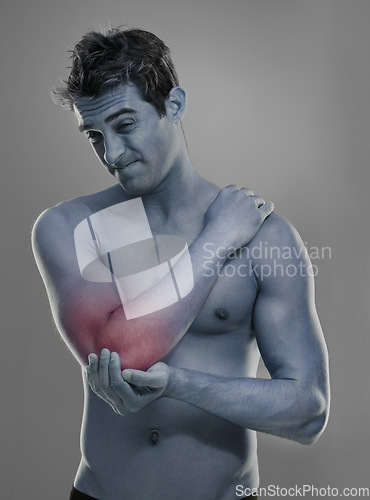 Image of Joint pain, arm injury and man with elbow problem, medical emergency and massage tendinitis. Red glow, osteoporosis and studio person with inflammation, accident or hurt anatomy on grey background