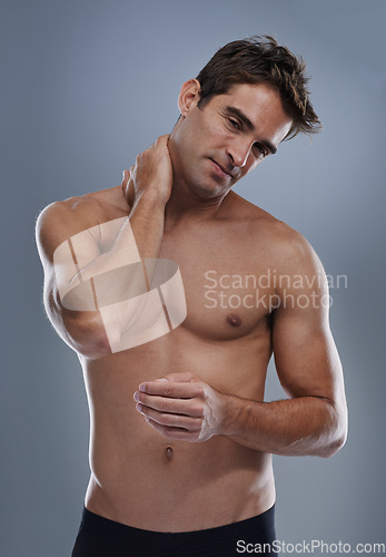 Image of Neck pain, studio and man with injury problem, medical emergency and massage muscle pressure. Inflammation, fibromyalgia or sore person with nerve tension, accident or hurt anatomy on grey background