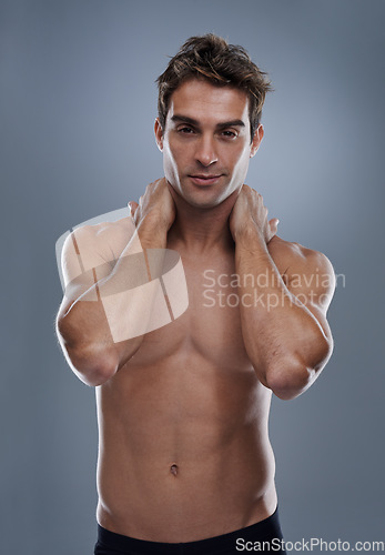 Image of Man, shirtless and portrait with confidence in studio or grey background with muscles for fitness, wellness or body care. Male person, model and topless with mockup space for stomach, exercise or abs