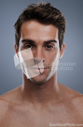 Image of Portrait, skincare and man with cosmetics, wellness and confident guy on grey studio background. Face, person and model with beauty or grooming with routine or dermatology with healthy skin or glow