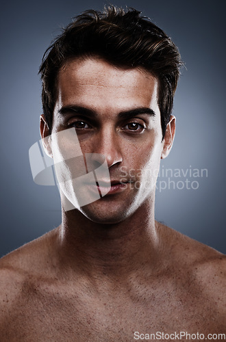 Image of Portrait, skincare and man with cosmetics, wellness and grooming on grey studio background. Person, guy and model with routine or treatment with luxury and shine with beauty, glowing or dermatology