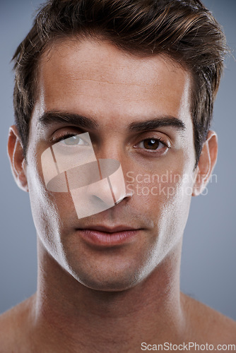 Image of Portrait, skincare and man with cosmetics, dermatology and confident guy on grey studio background. Face, person or model with beauty or grooming with routine or aesthetic with healthy skin or glow