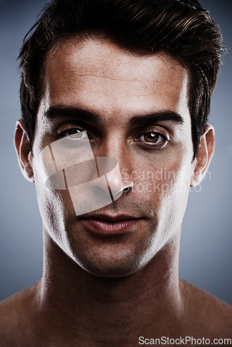 Image of Portrait, skincare and man with cosmetics, dermatology and grooming on grey studio background. Person, guy or model with routine or treatment with wellness or shine with beauty, glowing or confident