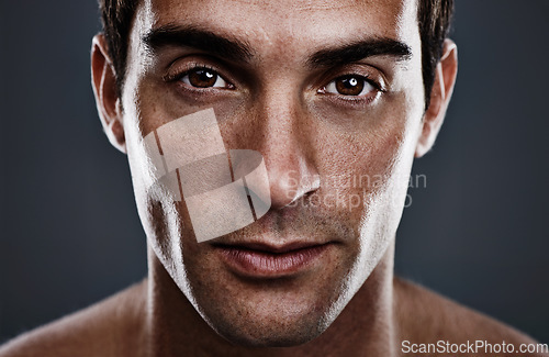 Image of Portrait, skincare and man with cosmetics, glow and grooming on grey studio background. Person, guy and model with routine or treatment with beauty and shine with beauty, wellness or dermatology