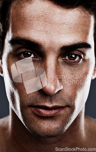 Image of Portrait, skincare or man with cosmetics, treatment or grooming on grey studio background. Person, facial or model with routine or confident with beauty or shine with beauty, glowing or dermatology