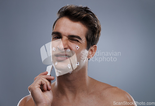 Image of Man, face and shave cuts or hygiene for hair removal or injury with blood, tissue or maintenance. Male person, grey background and dermatology with beard or clean health, wellness or mockup space