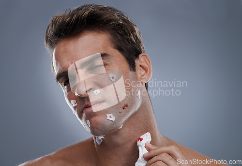 Image of Man, face and shave cuts for cleaning or hair removal hygiene or injury with blood, tissue or maintenance. Male person, grey background and dermatology with beard or health, studio or mockup space