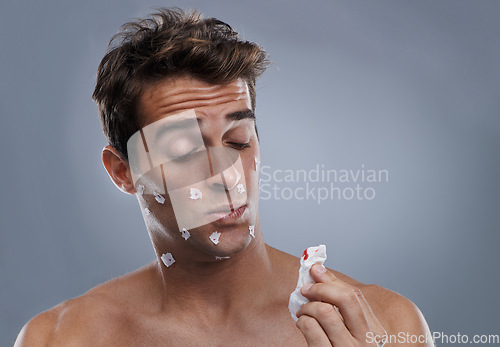 Image of Man, face and shave cuts or paper for hair removal hygiene or injury with blood, tissue or maintenance. Male person, grey background and dermatology with beard or clean health, studio or mockup space