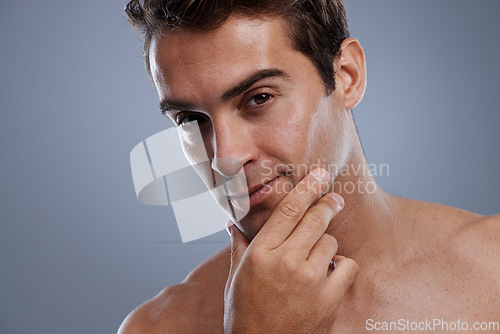 Image of Portrait, shaving and man with skincare, cosmetics and dermatology on grey studio background. Face, person or model with grooming routine or healthy skin with treatment, shine or confident with glow