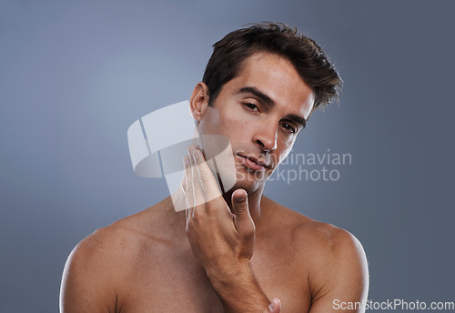Image of Portrait, glow and man with skincare, shaving and dermatology on grey studio background. Face, person and model with grooming routine and healthy skin with treatment, cosmetics and smooth with shine
