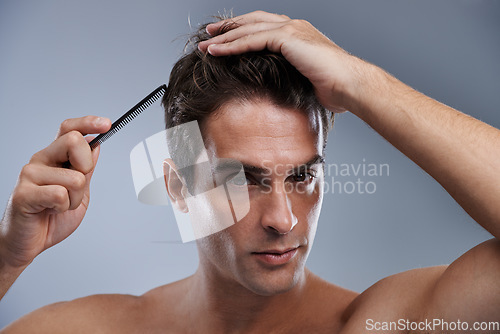 Image of Man, portrait and comb hair for grooming style on grey background for hygiene, self care and shirtless. Male person, model and face with brush for routine in morning or health, studio or mockup space