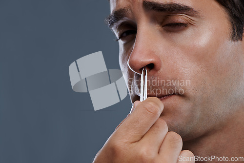 Image of Man, nose and hair with tweezers for cleaning on grey background for self care, wellness or hygiene. Male person, face and grooming for cosmetic beauty for healthy routine, studio or mockup space