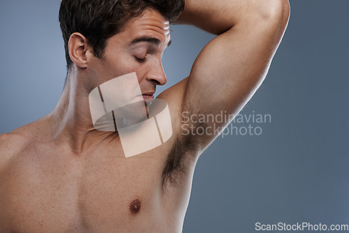 Image of Armpit, stink and man with poor hygiene, cosmetics and routine on grey studio background for deodorant, cleaning and skincare. Underarm, bad smell and model with hyperhidrosis, sweating and gross