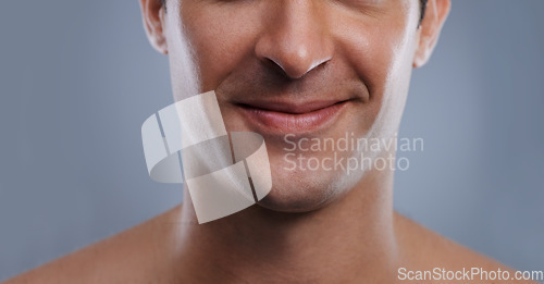 Image of Man, mouth and smile with skincare and lips with hygiene, jawline and satisfaction with treatment closeup. Grooming, confidence and face with male model in studio background for cosmetic shave