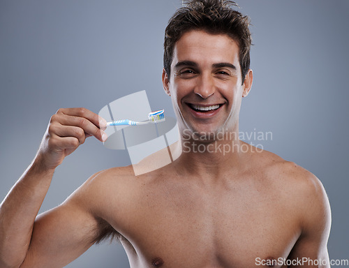 Image of Portrait, man and smile with toothbrush, dental hygiene and body care on grey studio background. Face, person and model with fresh breath and healthy with toothpaste and morning routine with wellness