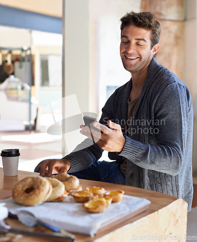 Image of Phone, smile and man with breakfast at restaurant networking on social media, mobile app or internet. Happy, food and young male person scroll on cellphone with healthy meal at cafe or coffee shop.