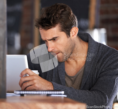 Image of Tablet, research and young man in cafe working on freelance creative project on the internet. Digital technology, reading and male designer freelancer on website for information in coffee shop.