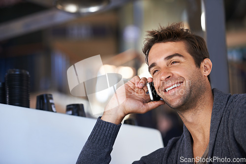 Image of Phone call, happy and young man networking for deal, good news or work communication in cafe. Smile, satisfaction and male person on mobile conversation with cellphone for career in coffee shop.