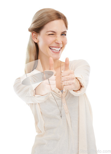 Image of Portrait, wink and happy woman with thumbs up in studio for support, trust or winning gesture on white background. Face, smile and female model with hand emoji for success, thank you or motivation