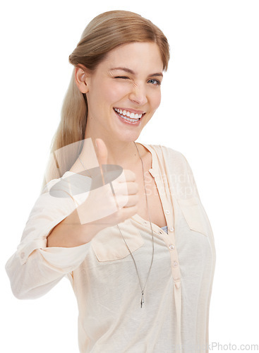 Image of Portrait, happy woman and wink with thumbs up in studio for support, trust or winning gesture on white background. Face, smile and female model with hand emoji for success, thank you or motivation