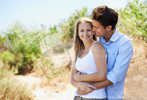 Image of Couple, portrait and smile in nature with hug in relationship for holiday, vacation or mockup space. Romance, man and woman or happy outdoor in forest with embrace for bonding, love or relax in woods