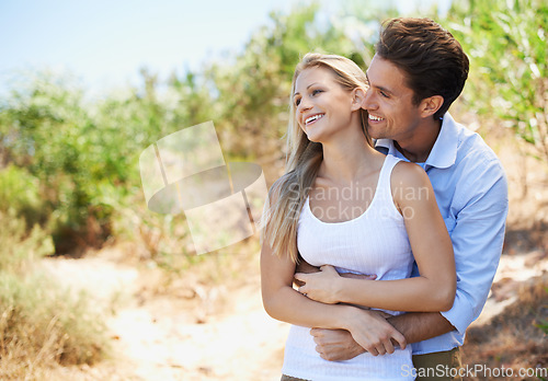 Image of Couple, love and happy in nature with hug in relationship for holiday, vacation or travel. Romance, man and woman with smile outdoor in forest with embrace for bonding, date or relax in woods