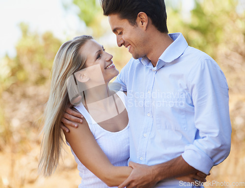 Image of Couple, face and happy or hug with travel in forest, nature or outdoor for holiday, vacation or trip. Romance, man and woman with embrace or smile for relationship, summer date or honeymoon with love