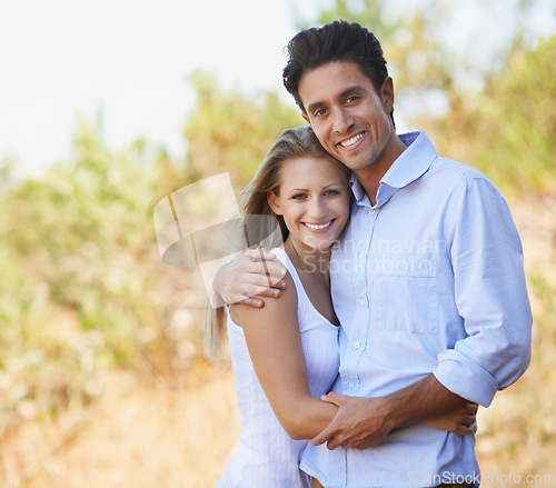 Image of Happy couple, portrait and hug in nature for embrace, bonding or love in support or outdoor affection. Face of young woman and man smile for comfort, trust or romance in forest or woods together