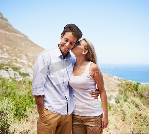 Image of Happy couple, love and kiss on mountains for travel, journey and holiday in nature with summer or valentines day. Young. romantic people hug on a date, hiking and tourism in Cape Town, South Africa