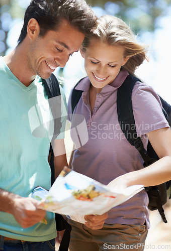 Image of Couple, hiking in nature and lost with map, documents guide or location information of forest travel or journey. Young woman and man trekking and planning or search paper for direction in the woods