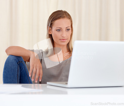 Image of Woman, laptop and relax in remote work for research, communication or networking at home. Young female person or freelancer working on computer, reading information or browsing internet at house