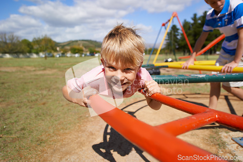 Image of Child, boy and fun on playground in portrait, smile and outdoor adventure on merry go round at park. Happy male person, carousel and energy on obstacle course, kid and playing on vacation or holiday