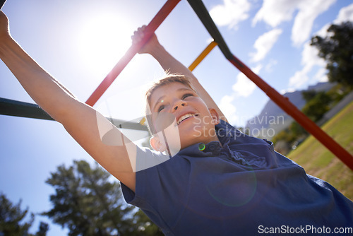 Image of Child, monkey bars and energy on playground, smiling and obstacle course on outdoor adventure at park. Happy male person, active and exercise on jungle gym, boy and fitness on vacation or holiday