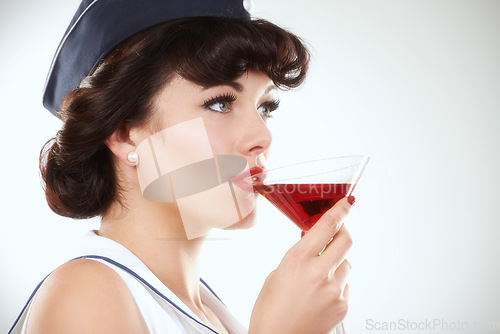 Image of Glass, stewardess and woman drink alcohol in studio isolated on a white background mockup space. Martini cocktail and an air hostess, vintage pin up girl model or flight attendant travel on journey