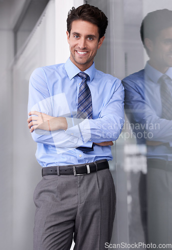 Image of Window, crossed arms and portrait of businessman in office with confidence, pride and ambition. Corporate entrepreneur, professional and happy worker for career, job and working in modern workplace