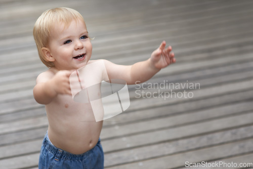 Image of Baby, playing on ground outdoor for development with relax, curiosity and early childhood in backyard of home. Toddler, child and crawling on floor for wellness, milestone or exploring with innocence