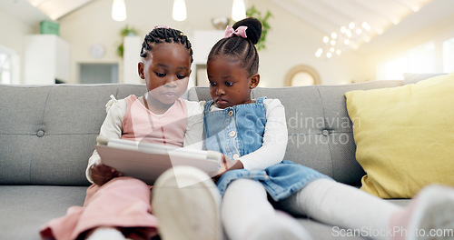 Image of Black girl children, tablet on sofa and online with elearning or watching cartoon movie, sisters at home and screen time. Young female kids, streaming and subscription to education app or film