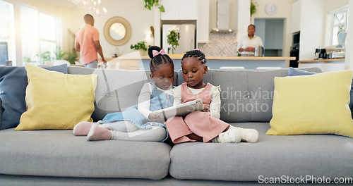 Image of Black girl children, relax with tablet on sofa and elearning or watching cartoon movie, sisters at home and screen time. Young female kids, streaming online and subscription to education app or film