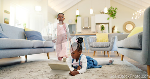 Image of Black girl children on ground with tablet and relax, elearning or watch cartoon movie, sisters at home and screen time. Young female kids, streaming online and subscription to education app or film